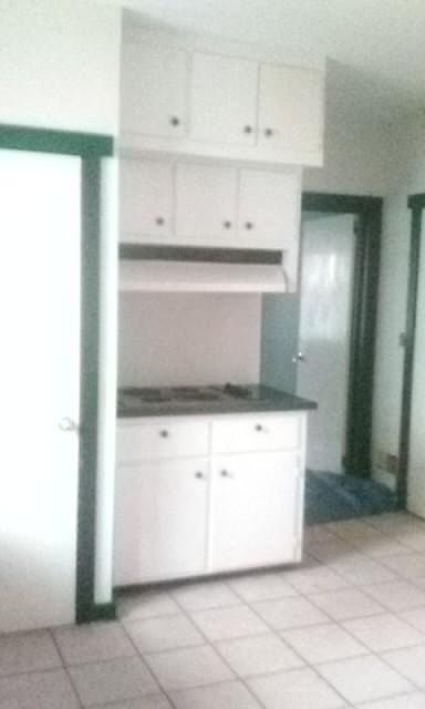kitchen stove; door on left is to laundry area; door on righ
