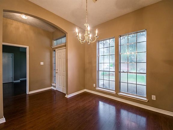 View of entry way . Secondary bedroom in back ground. Dining room in the fore ground.