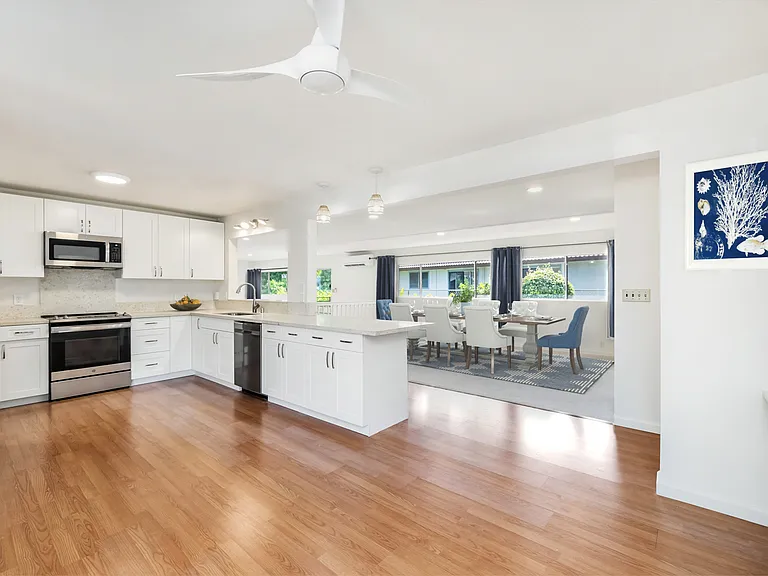 Big kitchen with lots of cabinets and counter space looking into dining area and family room. Lots of natural light. Indoor laundry to right of dining.