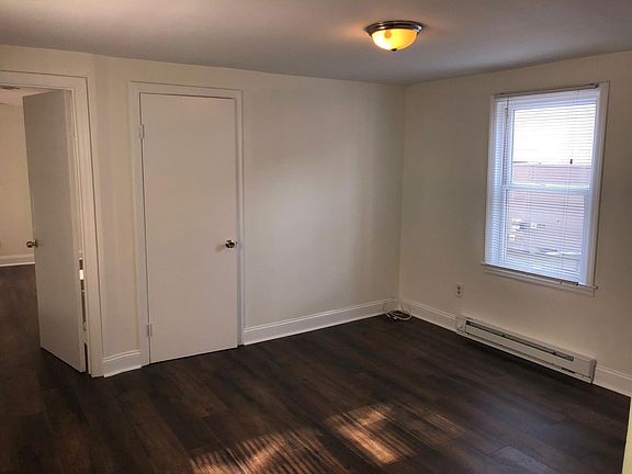 Comfortable living room with coat closet. New dark hardwood
