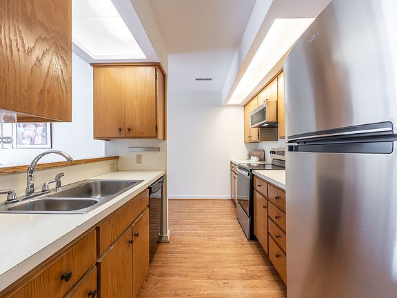 Kitchen features brand new stove, 2-year old refrigerator, microwave, dishwasher, large sink, and ample storage