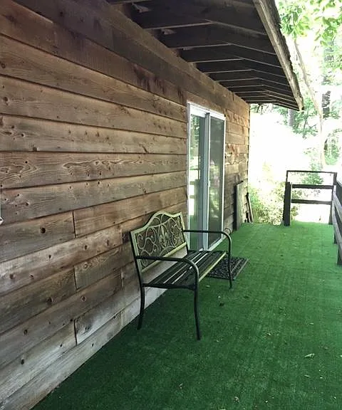 THIS IS ON THE DECK LOOKING TOWARDS THE STAIRS GOING DOWN. THERE IS A BRAND NEW BENCH TO SIT ON AND WATCH THE LAKE GOINGS ON. THE APT HAS CEDAR SIDING.