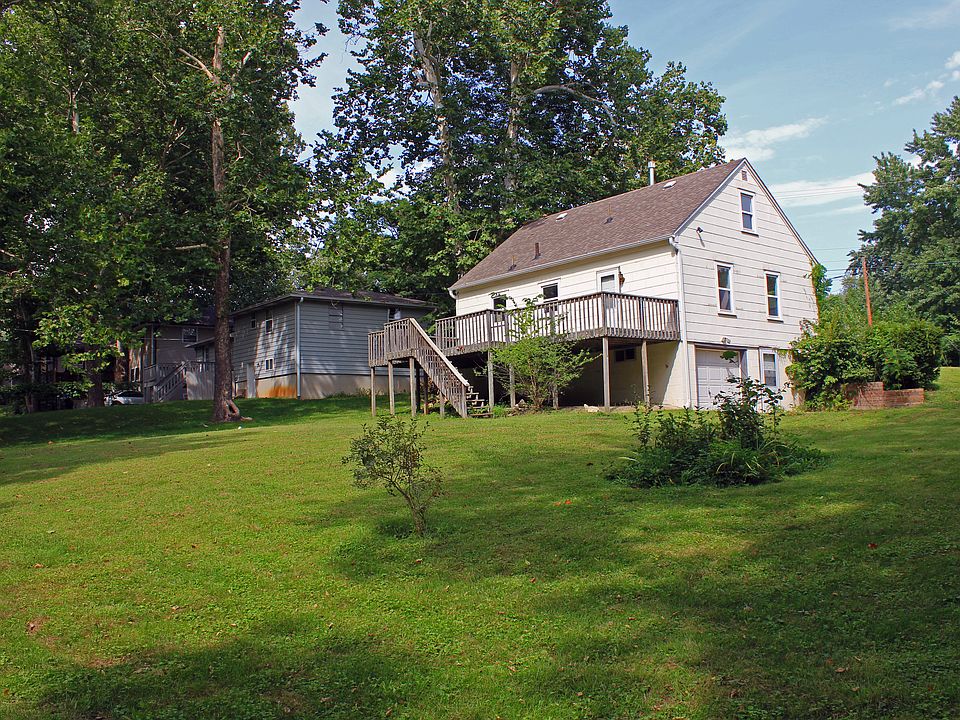 BACK YARD LOOKING TOWARDS DECK & BASEMENT GARAGE