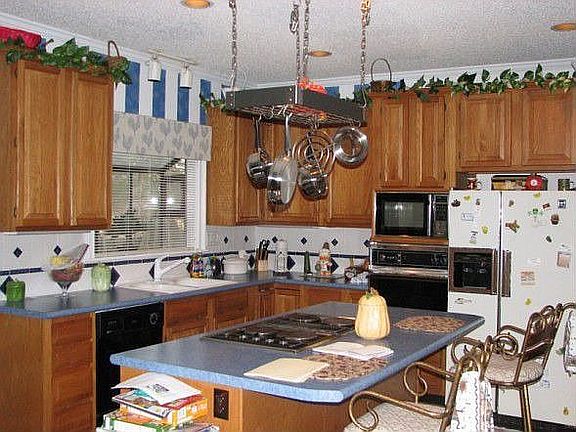 Kitchen with island, wood floor, recessed lighting