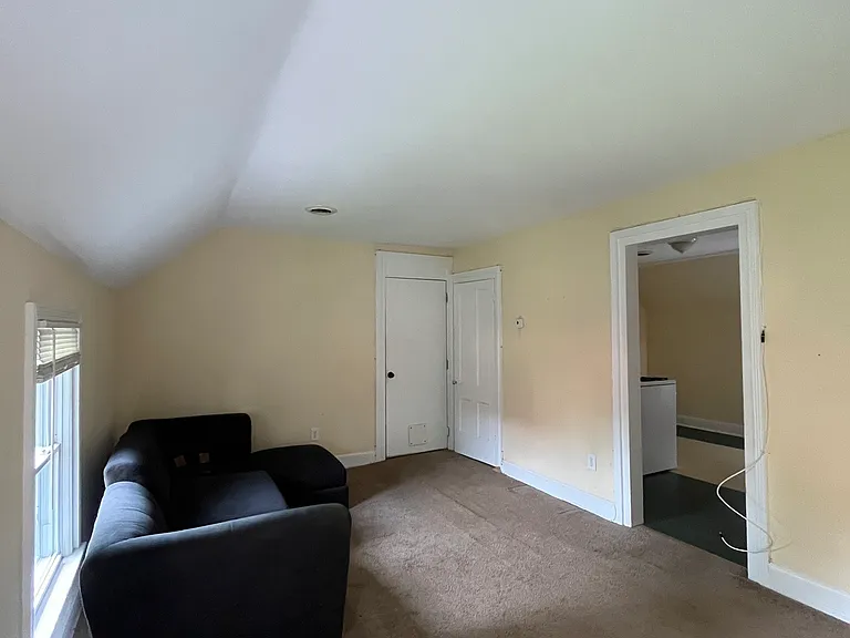 Living room
Opens into the kitchen on the right.
Main entrance and coat closet in view.
