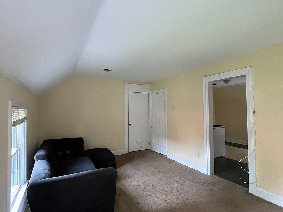 Living room 
Opens into the kitchen on the right. 
Main entrance and coat closet in view.