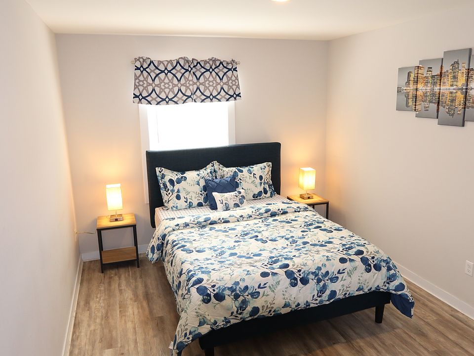 Primary bedroom with queen bed and stylish modern decor
