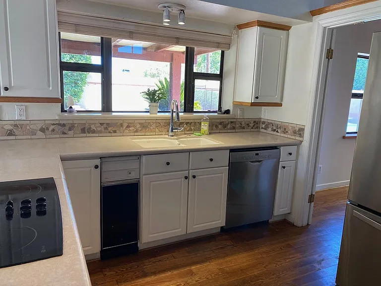 Kitchen with view of back patio and pool