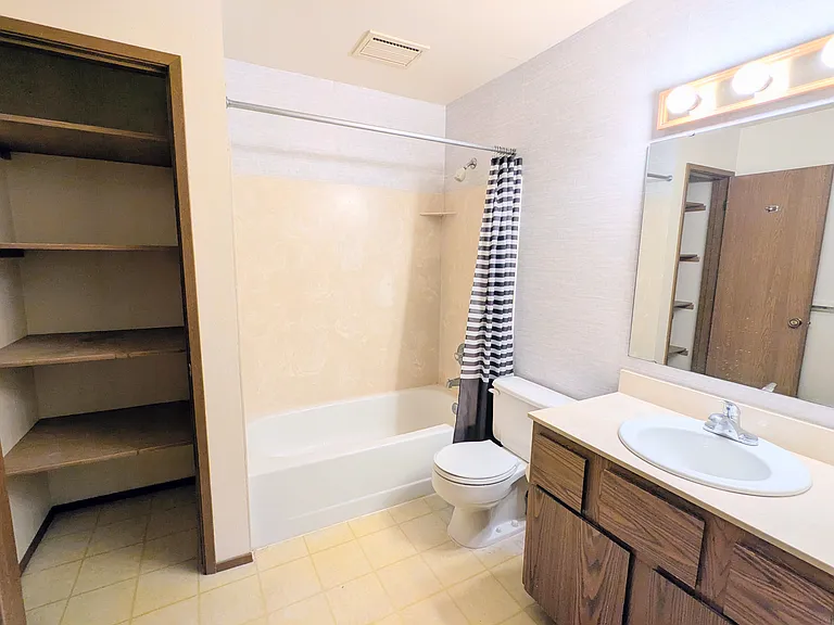 Full bathroom with linen closet