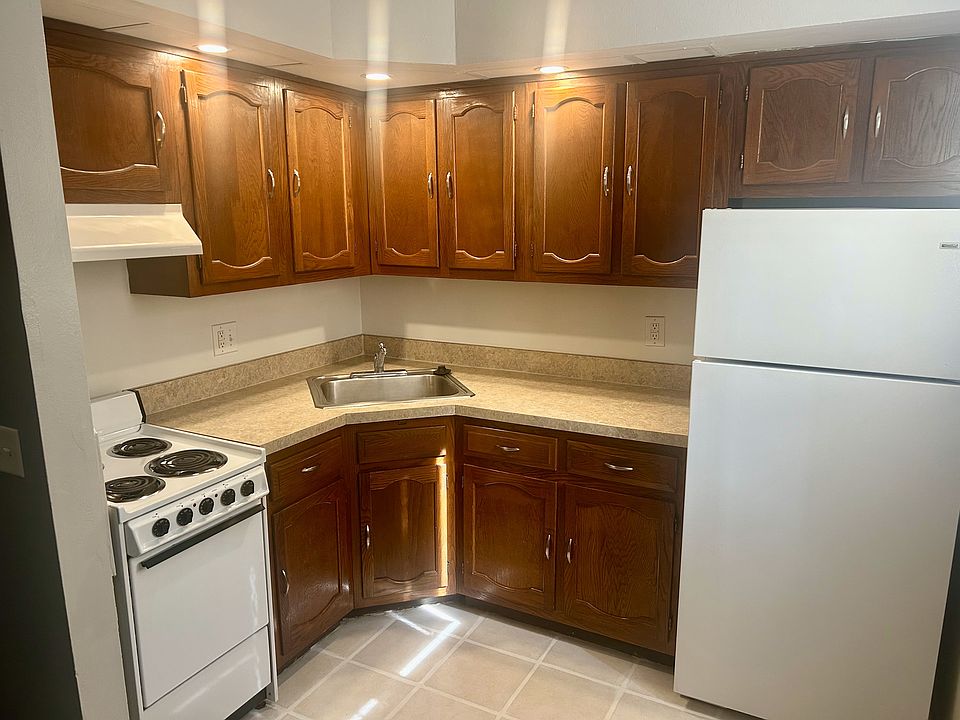 Open kitchen with corner sink and garbage disposal.