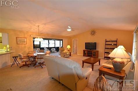 Living/Dining room with cathedral ceilings.
