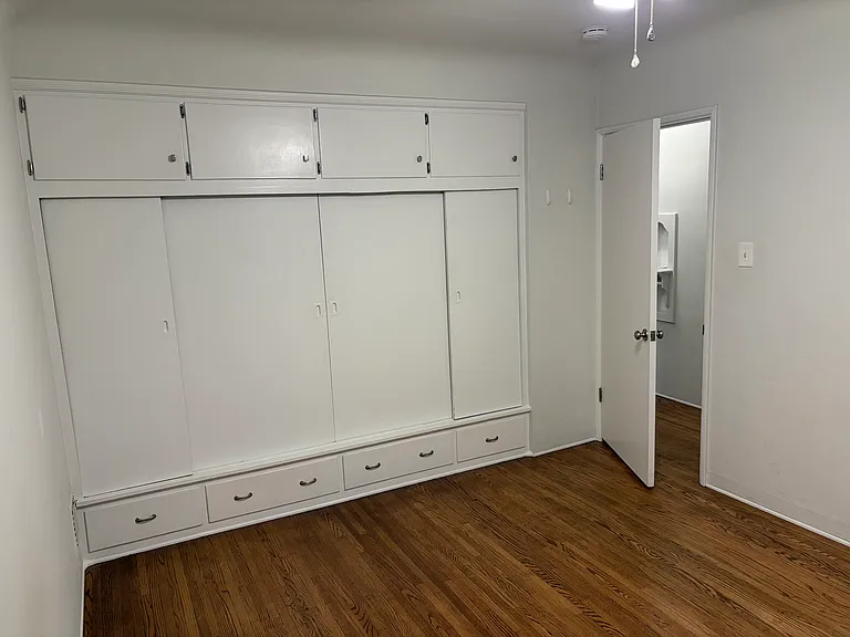 Closets in each room with built in shelves, drawers, and storage above closet.