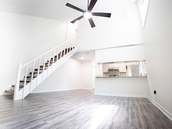 Vaulted living room with skylight windows and kitchen pass-through
