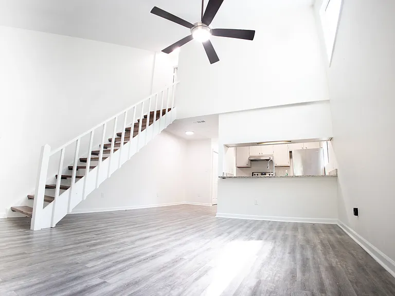 Vaulted living room with skylight windows and kitchen pass-through