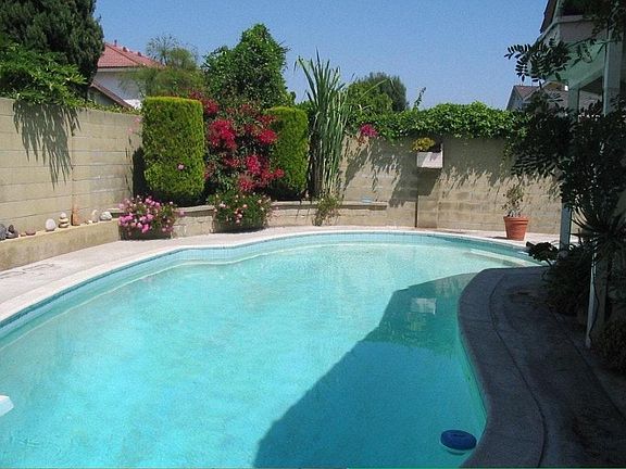 fenced pool in back yard
