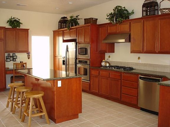 Kitchen with granite, cherry wood & stainless steel