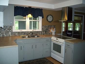 Kitchen with view of backyard and sunroom.