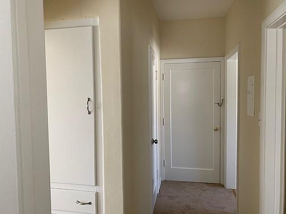 Hallway and access door to interior stairway and mail slot