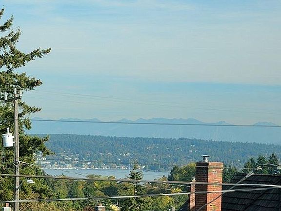 Partial views of mountains and Lake Washington.