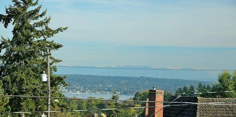 Partial views of mountains and Lake Washington.
