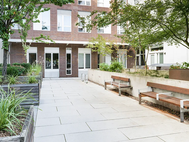A quiet courtyard at Modera Belmont, offering a leafy retreat just steps from Belmont's cafes, boutiques, and neighborhood favorites.