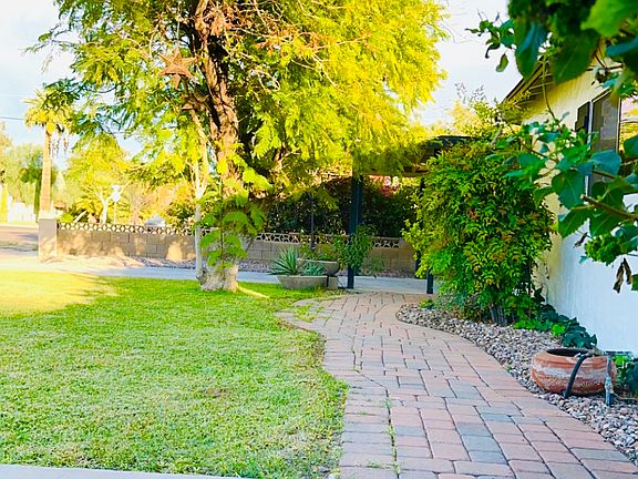 Walkway in front of home w/ view of driveway