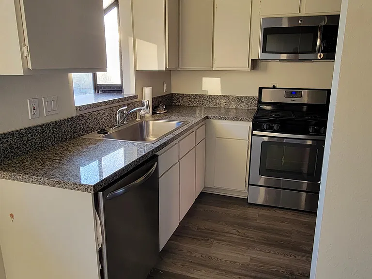 Kitchen: Granite Countertop, Dishwasher, Stainless Steel Sink w Garbage Disposal, Stove, Microwave & Lots of Cabinets
