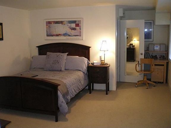 Large bedroom with neutral berber carpet.