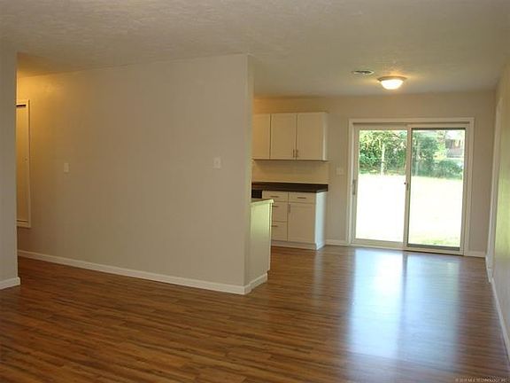 Looking towards dining area & kitchen from living room. Nice slider to back yard.