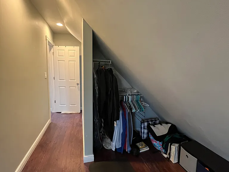 3rd floor west bedroom - closet and hallway leading to the ensuite bathroom. This bedroom is a L shape.