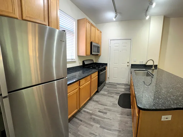 Side View of Kitchen. Plenty of Granite Counter-Tops