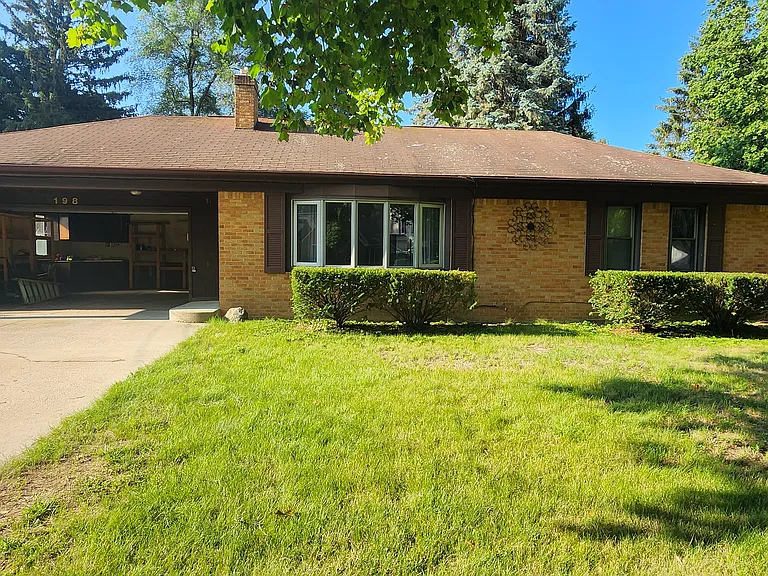 Front of house with nice wide driveway.