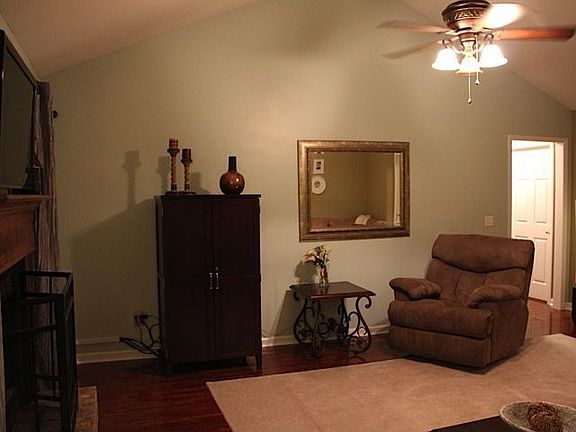 Another view of living room showing the vaulted ceilings and gorgeous hardwood