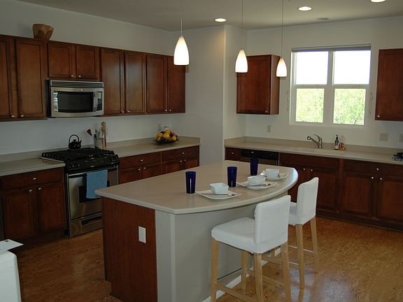 Bright open kitchen has loads of counter-space and cabinets.