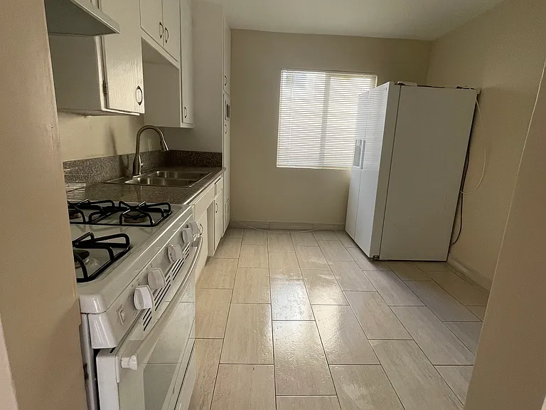 Kitchen furnished with fridge with water line and stove