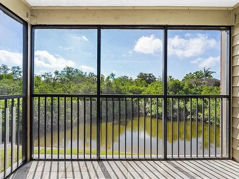 Beautiful enclosed screen porch overlooking private pond.