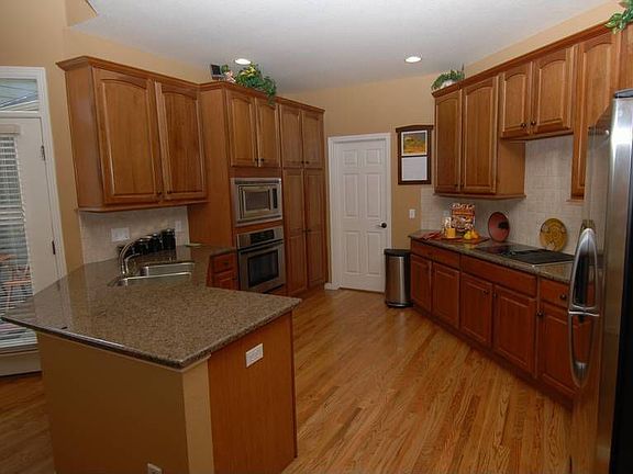 Modern kitchen with slab granite & stainless steel Jenn-Aire appliances