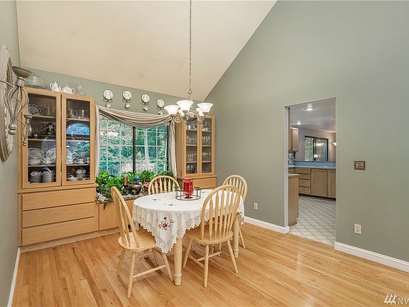 Dining room off the living room has custom built ins, easy access to kitchen for hosting gatherings; lots of natural light from backyard