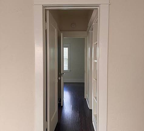 The hallway features a recessed shelf area for display or a library