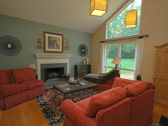 The Den/Great Room also has hardwood flooring and contemporary lighting.