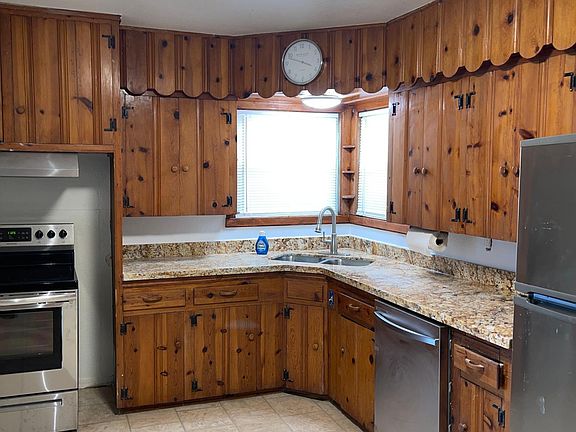 kitchen with stainless steel appliances and plenty of new granite countertop space