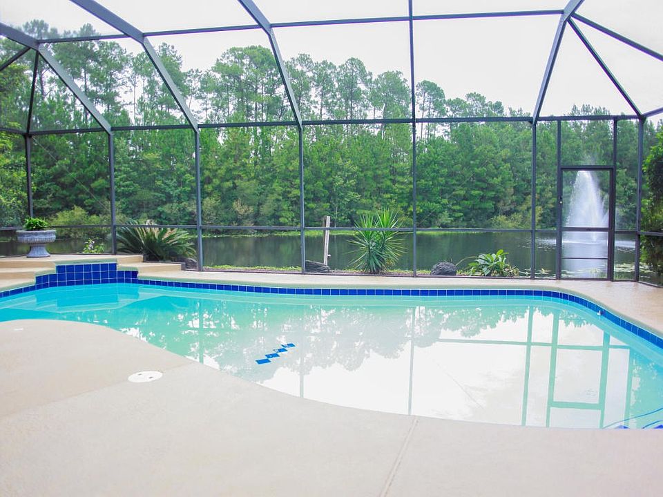 view from back porch of pool and pond