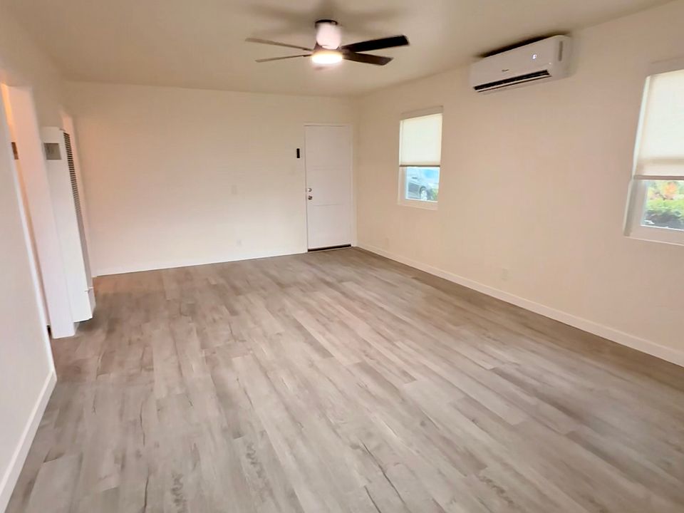 Spacious Living Room with Newer flooring, New Dual Pane Windows, 18,000BTU Brand New Mini Split Cool/Heat with Remote Start, Bluetooth Controlled Fan with White & Soft Lighting