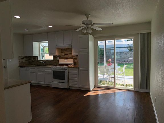 Open kitchen dining area, slider to cover patio and large rear yard and spa.