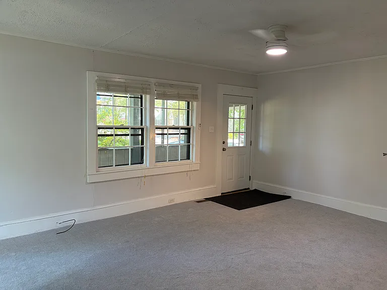 Living room looks out to the screened porch. New ceiling fan.