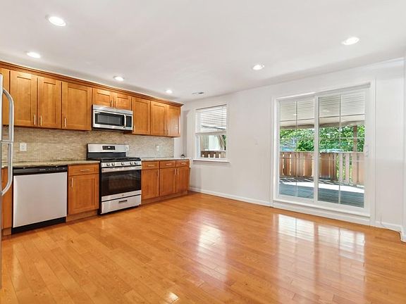 Bright open kitchen leading to covered back deck.