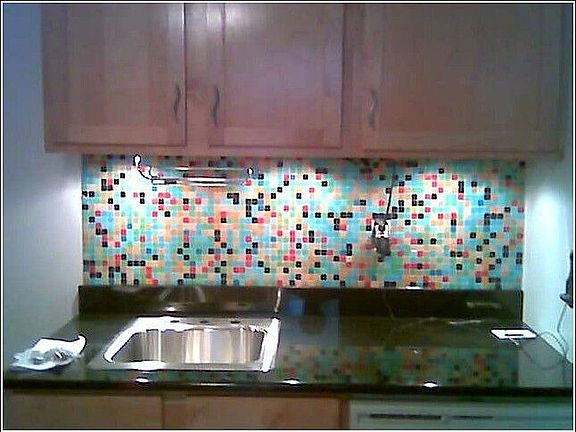 Black granite slab and custom mosaic tile install