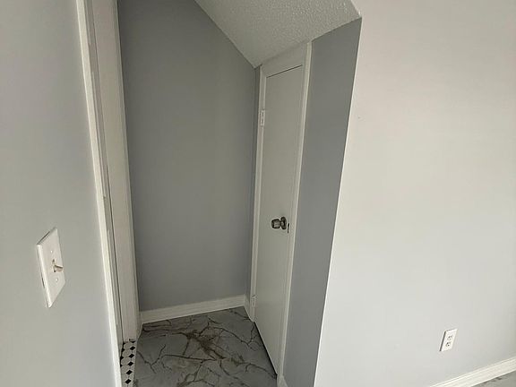 Access to Half Bathroom and the Storage Room Under the Stairway