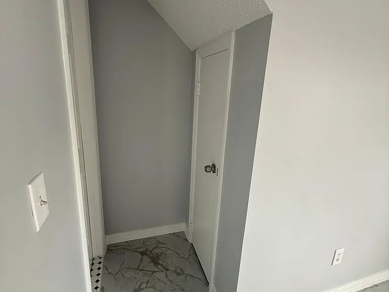 Access to Half Bathroom and the Storage Room Under the Stairway