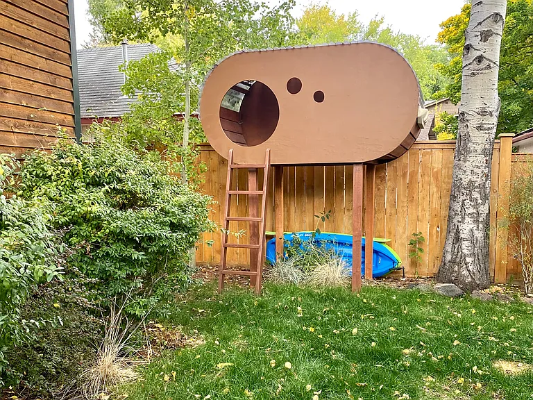 Kids playhouse in the fully fenced backyard